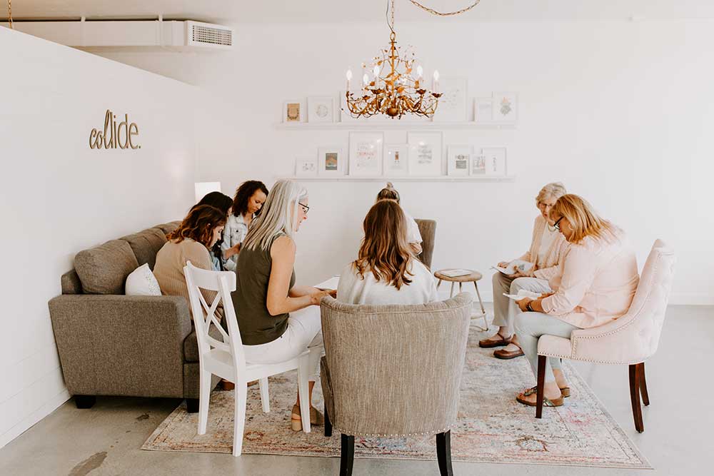 Collide blog women in a circle of chairs in the cozy new Collide home