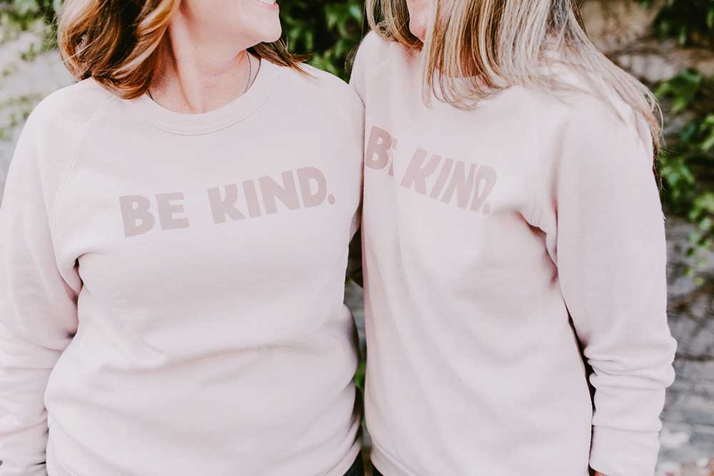 Collide blog two friends side by side wearing Be Kind sweatshirt from Collide store desiring a reputation of being kind