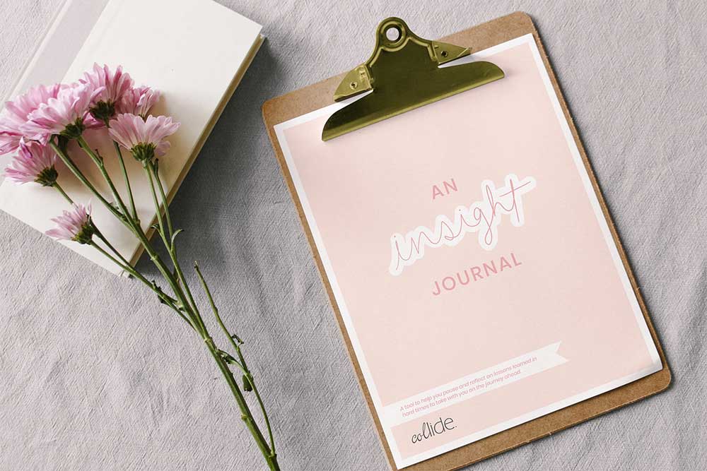 Insight Journal on clipboard sitting on bed