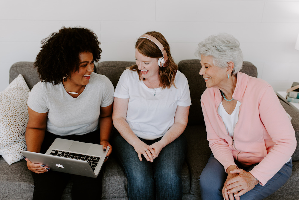 three women listening to music on a computer