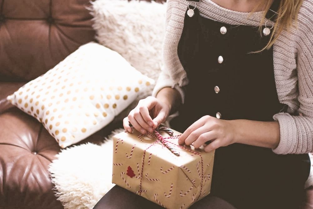 woman opening a gift on christmas