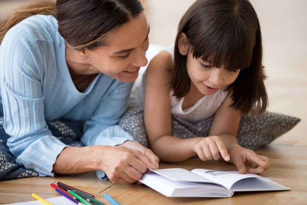 mother reading to school age daughter