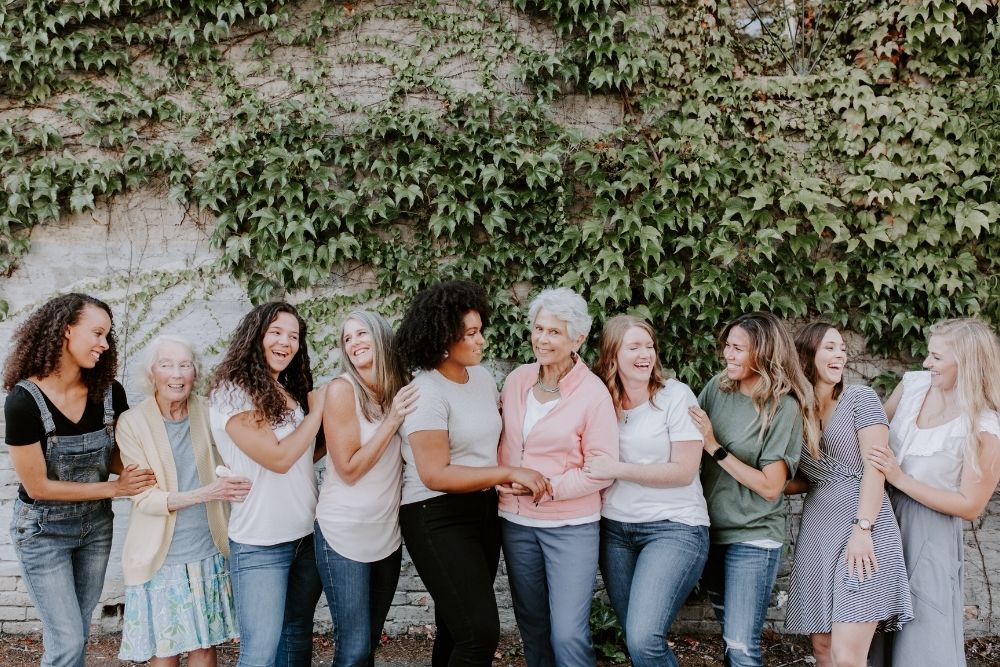 collide counseling bundle feature photo group of happy women outside ivy wall