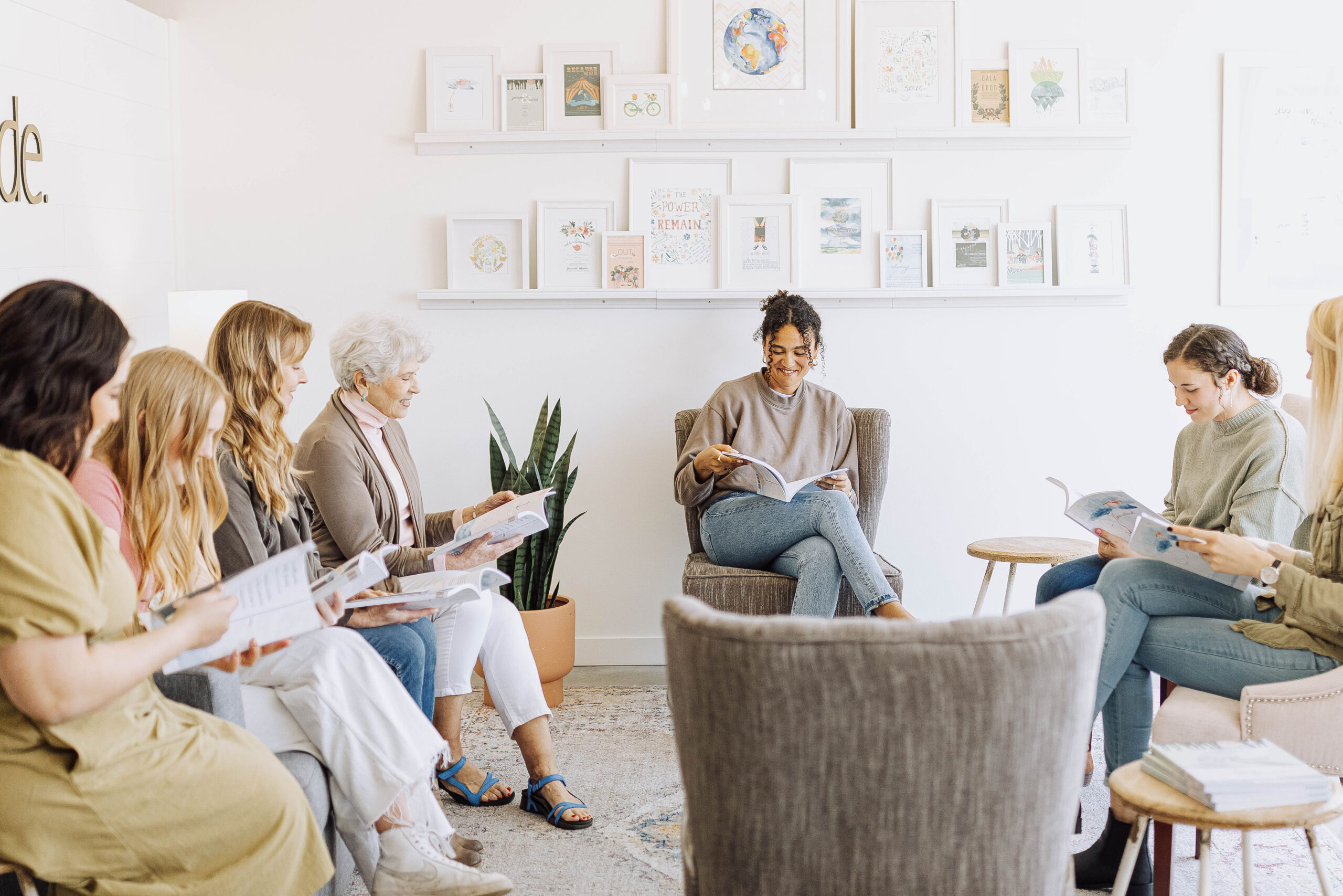 Group of women sitting at the collide office talking and holding bible study books