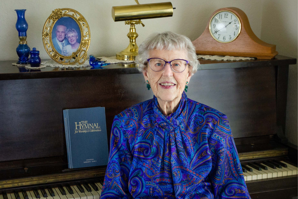 Older woman sitting in front of piano