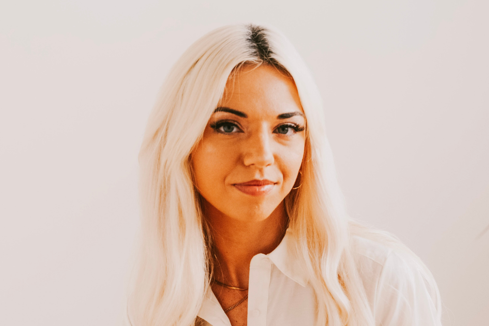 Hanna Grownowski Barnett Headshot with blond hair and white shirt