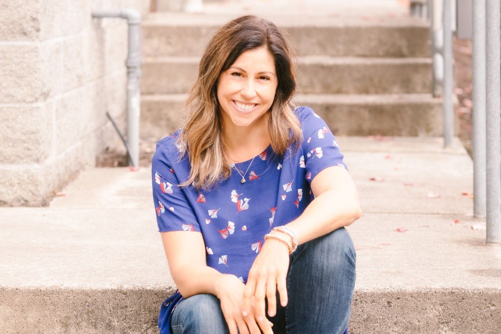 headshot of therapist kristyn than sitting on stairs