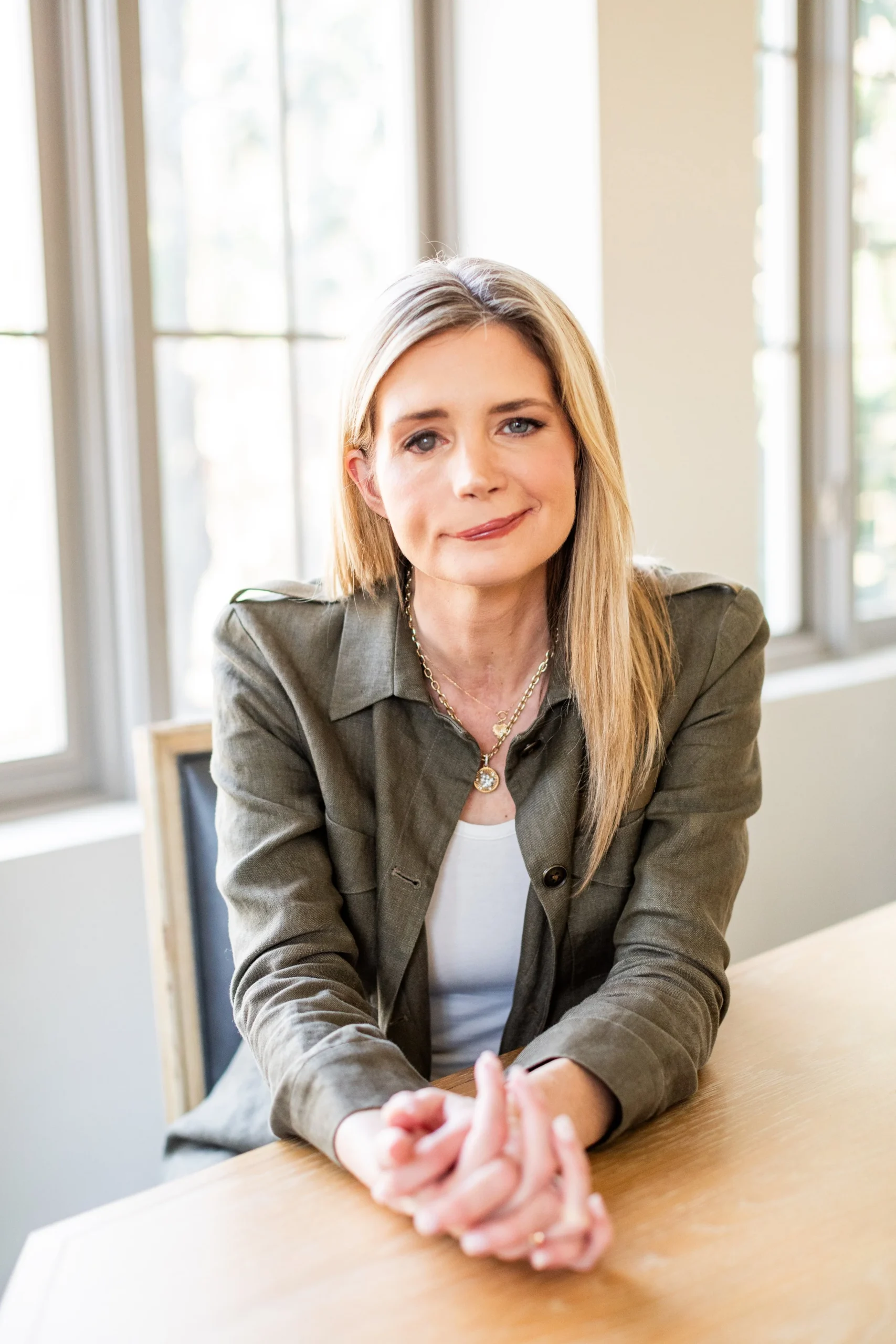 katherine wolf headshot sitting at a table